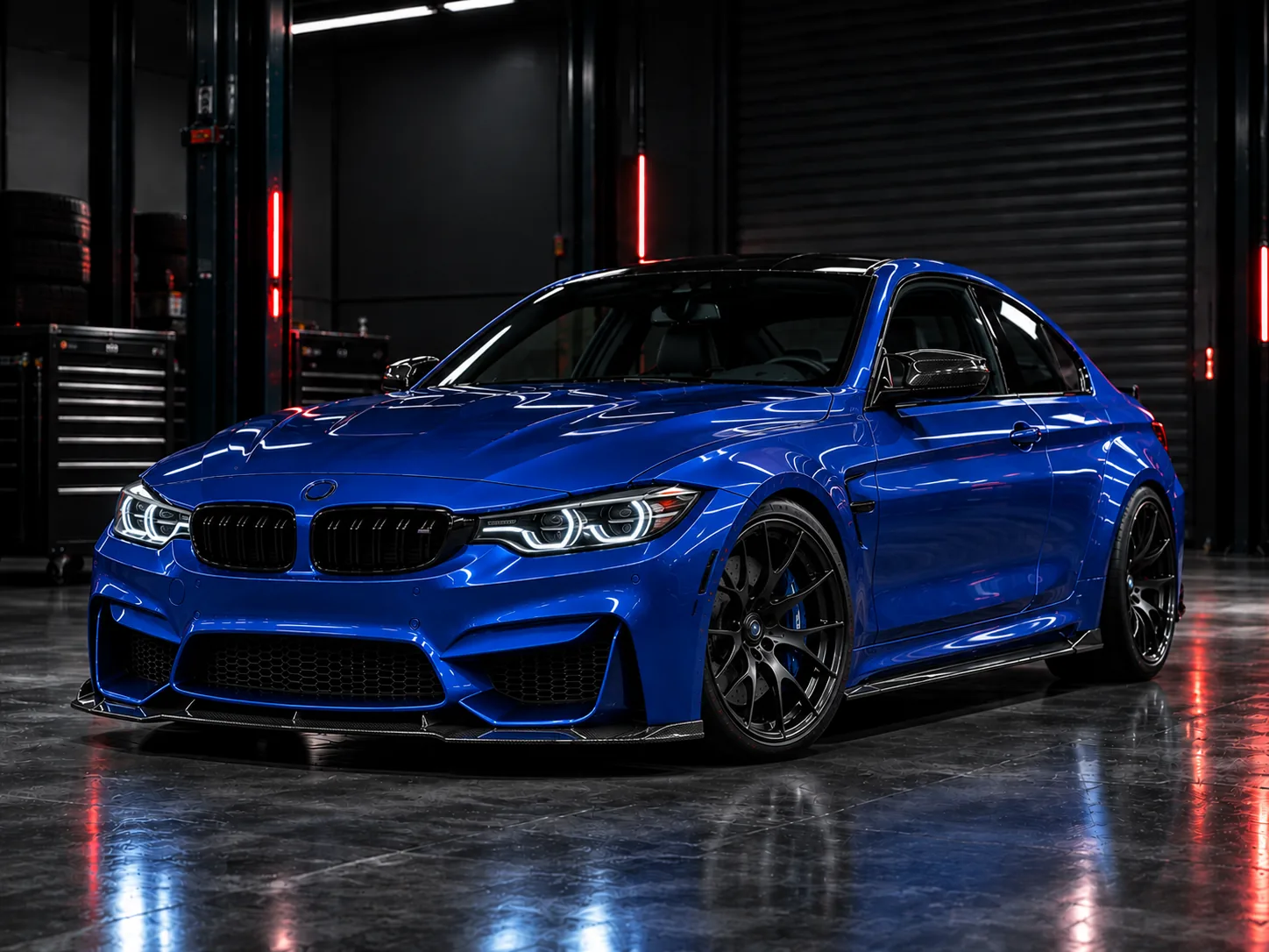 Blue performance sedan, front three-quarter view in the workshop