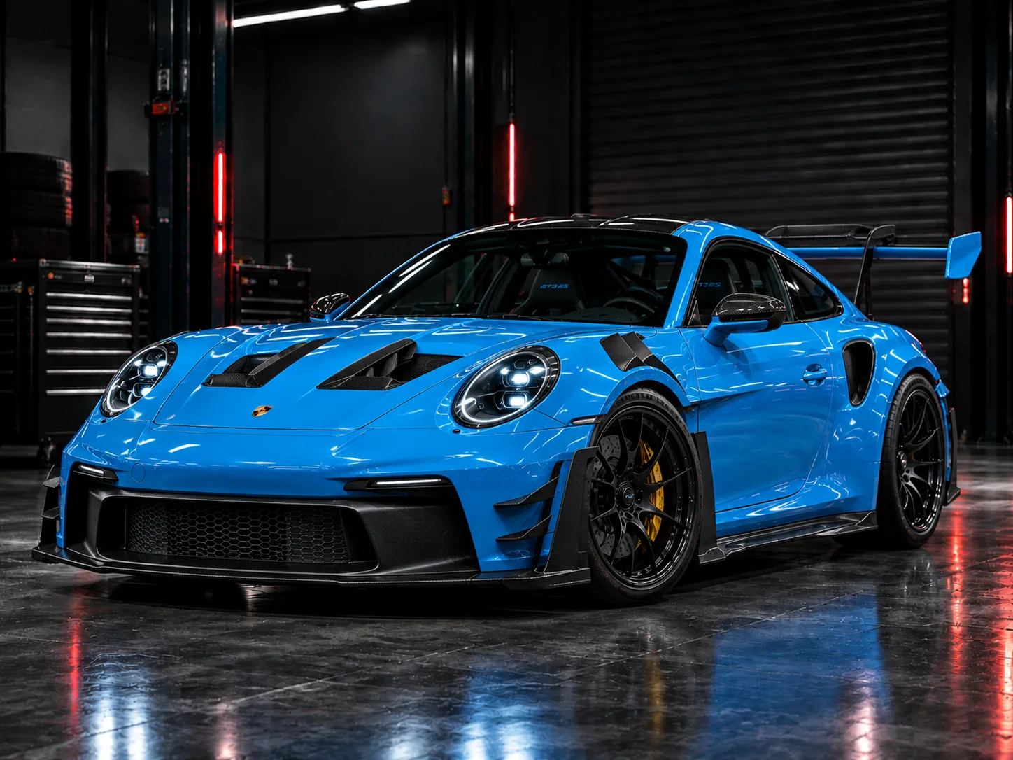 Blue track-focused sports car in the workshop